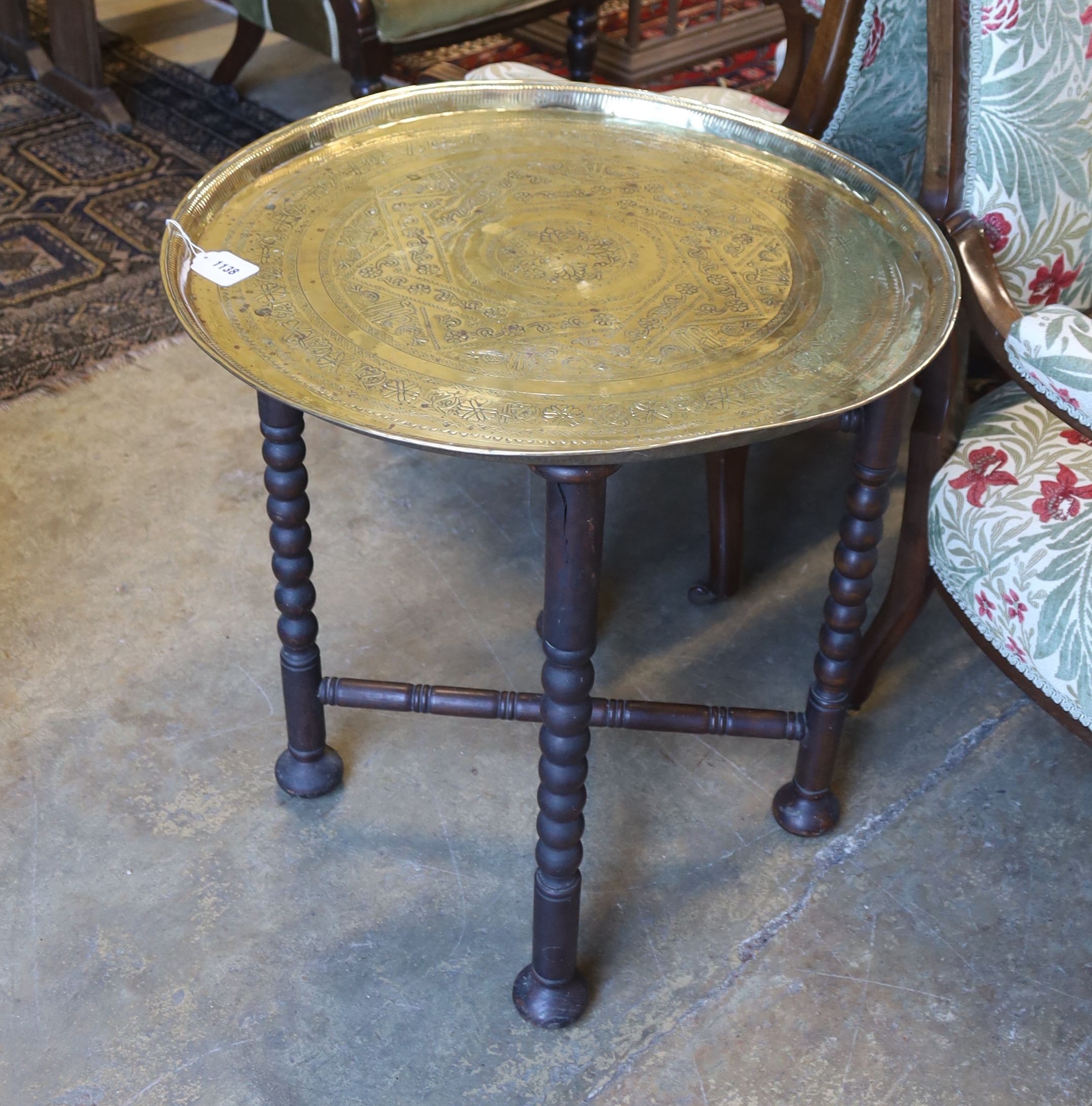 An brass engraved Benares table, diameter 62cm, height 65cm